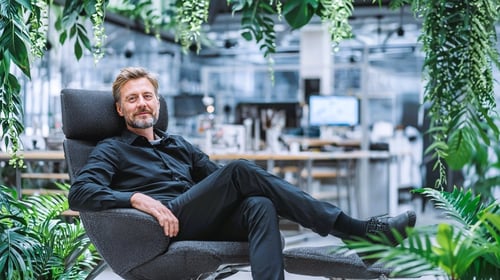 Production manager sitting in a manufacturing environment with subtle jungle vines symbolizing digital complexity in production planning Production manager sitting in a manufacturing environment with subtle jungle vines symbolizing digital complexity in production planning